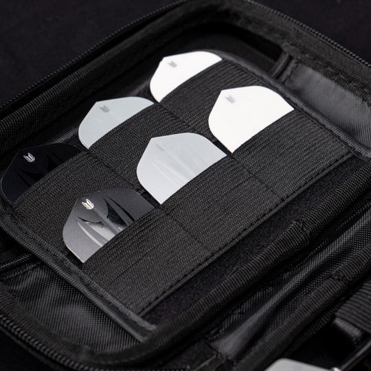Estuche de dardos Chris Dobey de la serie Ghost de Takoma XL Das Bild zeigt das „Target Takoma Bolide XL Dartcase“, das mehrere Dart-Flights in schwarzen und weißen Farben organisiert aufbewahrt. Die Flights sind sicher in elastischen Halterungen im Inneren des schwarzen Etuis verstaut.