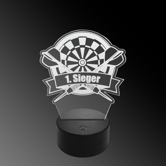 Lámpara de dardo LED de plexiglás con texto personalizado Das Bild zeigt eine LED-Lampe mit einem Plexiglasaufsatz in Form eines Dartboards und zwei gekreuzten Darts. Auf dem Schild steht "1. Sieger" geschrieben.